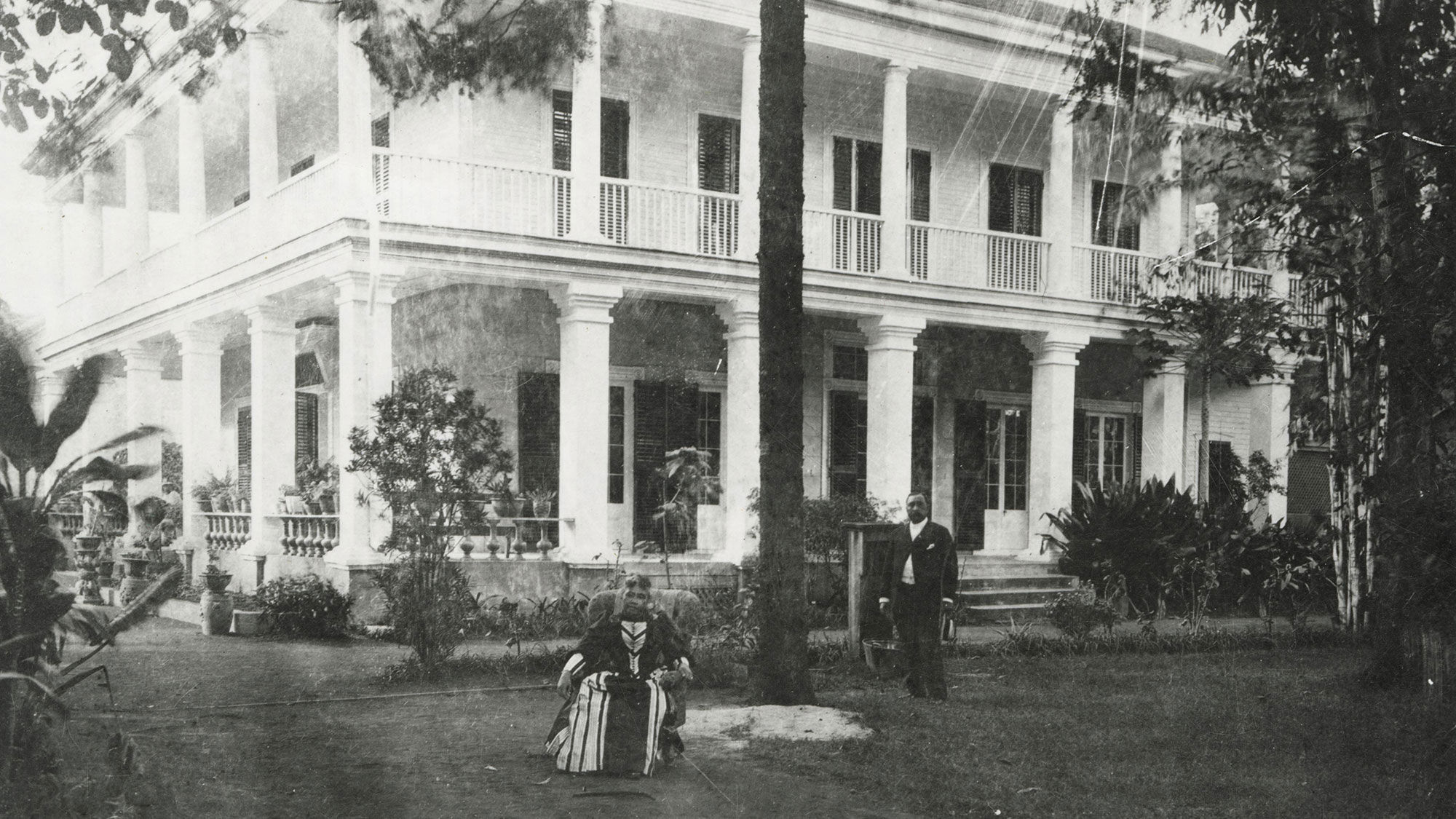 Queen Liliuokalani sits outside Washington Place, which was her home from 1862 to 1917.