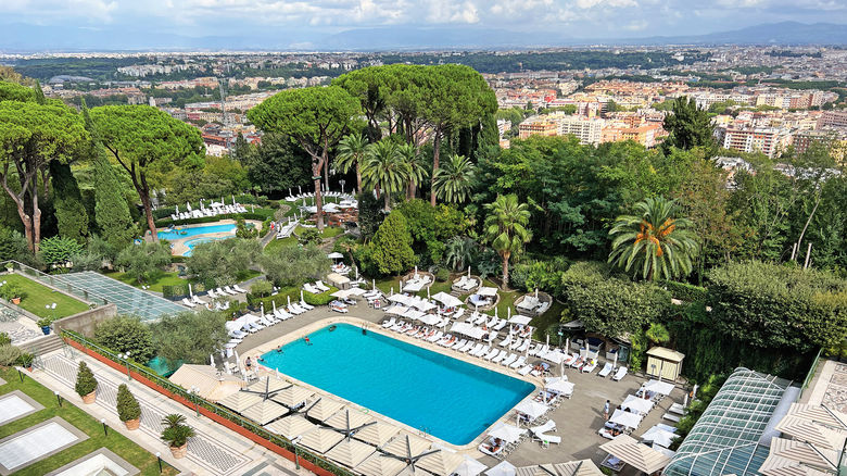 The outdoor swimming pools at the Rome Cavalieri, a Waldorf Astoria Hotel, with the city beyond.
