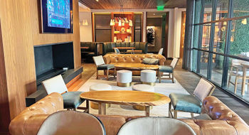 The cozy living-room vibe of Bayou & Bottles at the Four Seasons Hotel Houston.