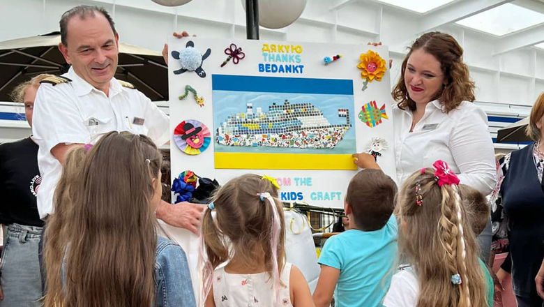 Staff on the Volendam receive a tiled mosaic of the ship from children of Ukrainian families.
