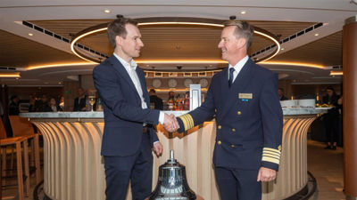 Arnt Inge Gjerde (left), yard director for Vard Soviknes, shakes hands with Viking Polaris Capt. Olivier Marien.