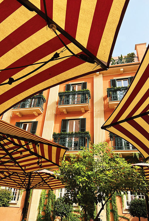 The cheerful tan-and-red umbrellas in the courtyard of Rocco Forte Hotels' Hotel de la Ville in Rome. The cheerful tan-and-red umbrellas in the courtyard of Rocco Forte Hotels' Hotel de la Ville in Rome.