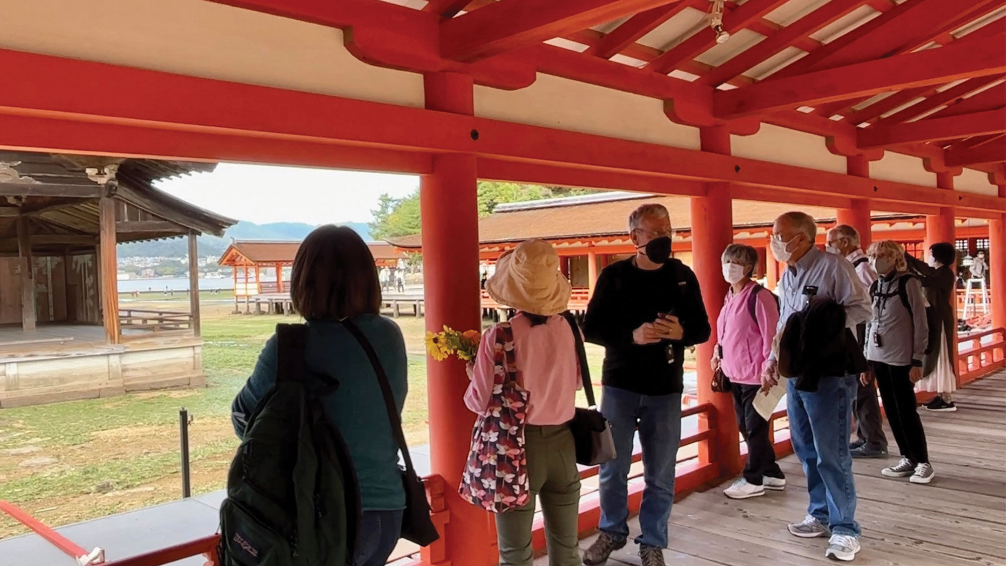 Visitors with an Alexander + Roberts tour group explore the Itsukushima Shinto shrine in Miyajima, Japan.