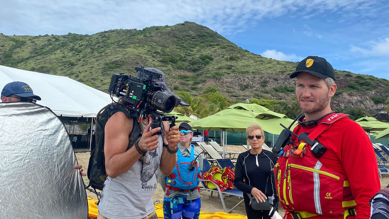 Kayak guide Santiago Stabile, ringed by a production team, talking to Seabourn Venture guests ahead of an excursion in St. Kitts.