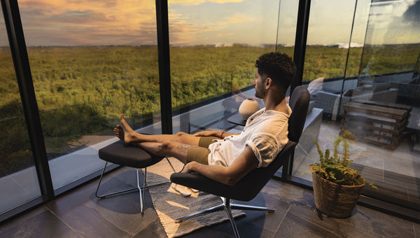 A guest relaxes in a modern workspace that can be booked at the Sensira Resort & Spa in Cancun.