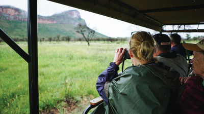 Collette travelers on safari land and river tour in southern Africa.