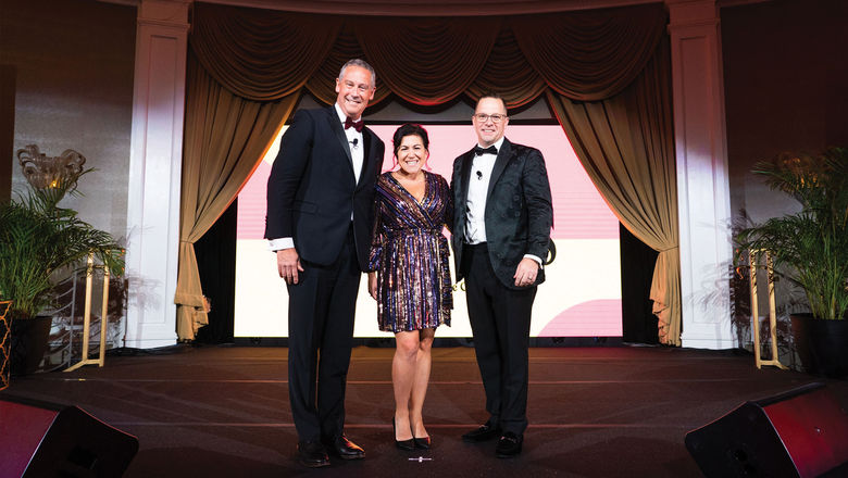Ensemble executive chairman David Harris (left) and president Michael Johnson (right) with Lauren Doyle, president of the Travel Mechanic, who won Ensemble's Reinvention Award during the event.