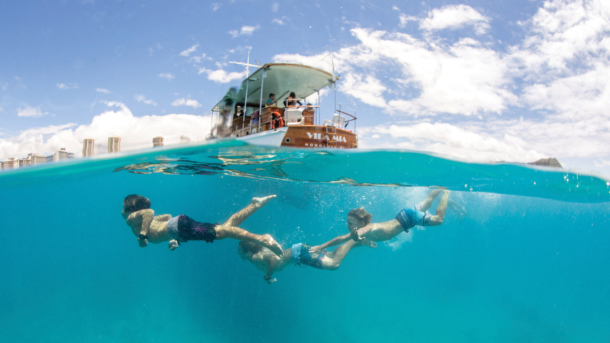 Guests take to the sea on a Vida Mia private charter. The motoryacht was built in 1929 and served in World War II.