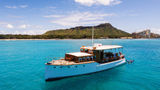 During a private charter, the Vida Mia anchors at a great swimming spot with Diamond Head as the backdrop.