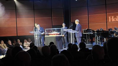A presentation to mark HAL's 150th anniversary was held aboard the Rotterdam in New York on Oct. 26, From left, Stephen Lean, director of the American Family Immigration History Center at Ellis Island (partially hidden), Rotterdam Capt. Werner Timmers, ship's bosun Andy Budiman and HAL president Gus Antorcha.