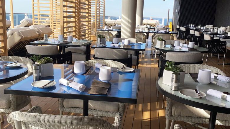 The Haven outdoor restaurant leads to the secluded sun deck with an infinity-edge pool that looks off the aft.