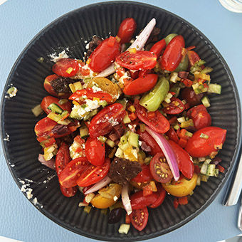 A bright Greek salad brings a pop of color to a pool-bar lunch.