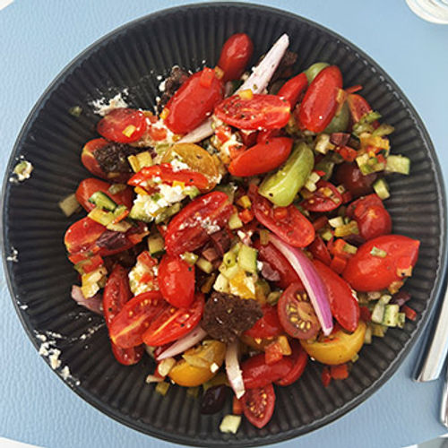 A bright Greek salad brings a pop of color to a pool-bar lunch.
