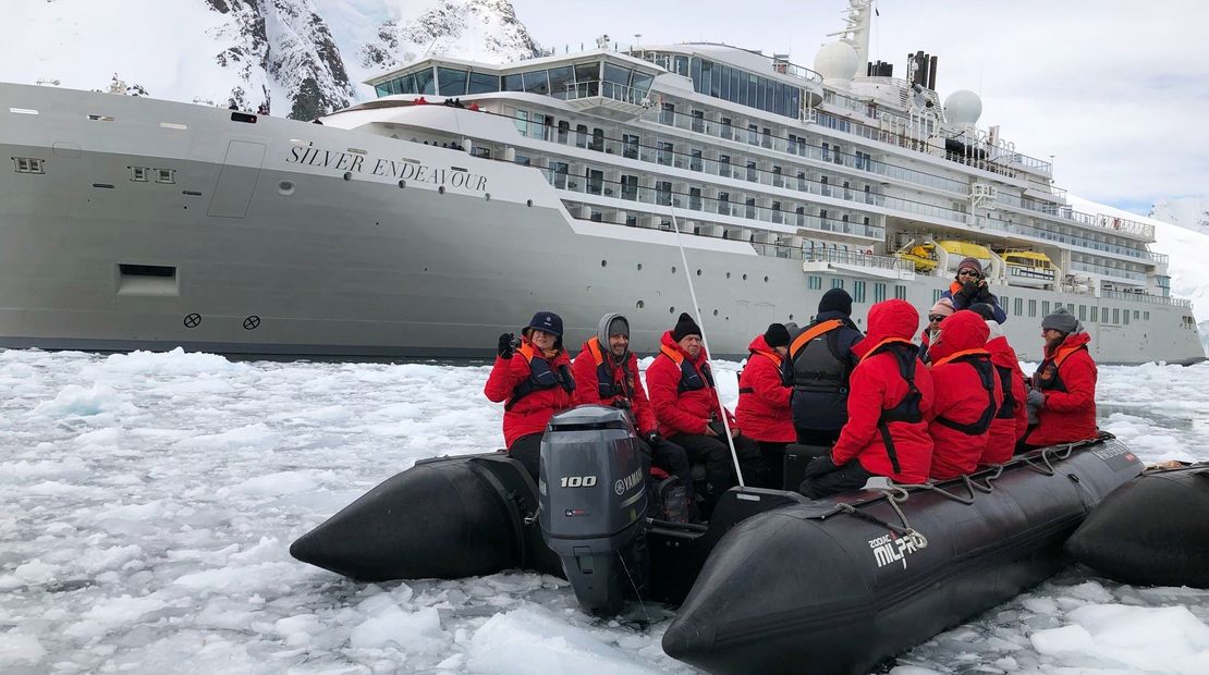 Passengers in Zodiacs observing the renaming ceremony of the Silver Endeavour in Antarctica.