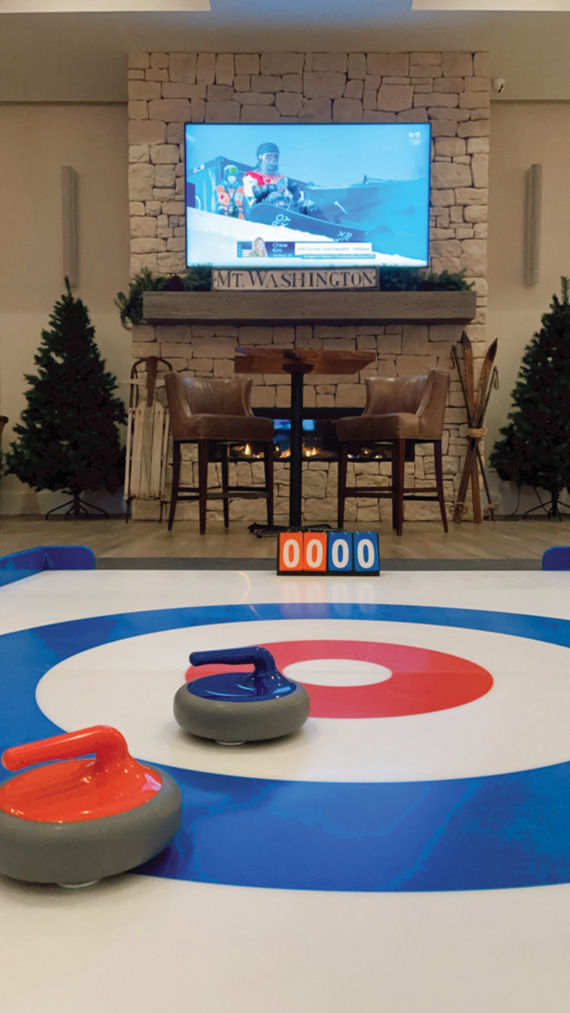 A ski-inspired lounge area and curling rink at the Pelham House Resort.