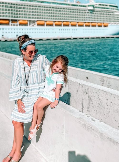 Jamie Margolis Ross and daughter Audrey on the Nassau pier with Independence of the Seas in the background.