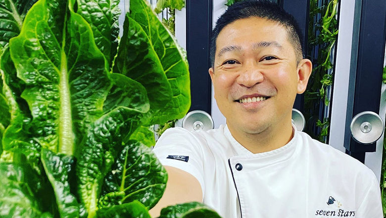 At the Seven Stars Resort & Spa in Turks and Caicos Chef Edwin Gallardo shows a harvested Romaine lettuce head. The resort installed a container to grow delicate greens and herbs.