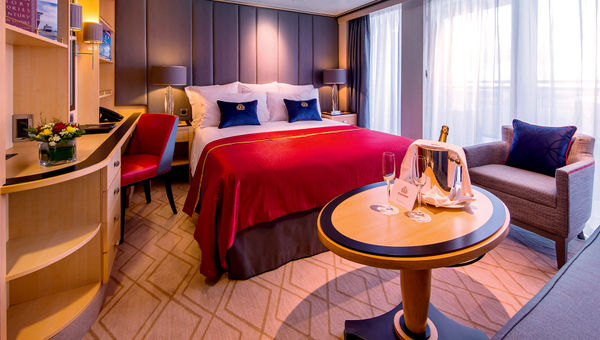 The Queen Mary 2's Princess Grill Suites feature a bathtub, walk-in closet, sitting area, plush bed and large balcony.