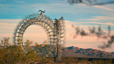A Spiegelworld performer poses atop a Clayton Blake sculpture in Nipton, Calif.