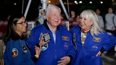 Viking Neptune godmother and retired NASA astronaut Nicole Stott (left) stands with Viking chairman Torstein Hagen and Viking executive vice president Karine Hagen.