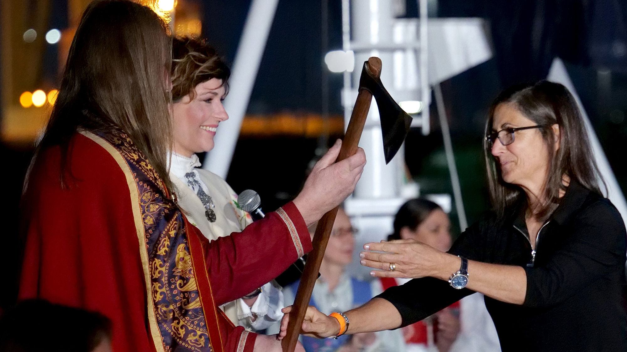 Viking Neptune godmother Nicole Stott (right) was presented a Viking broad axe to cut the ribbon to send a bottle of Norwegian crashing into the ship’s hull.