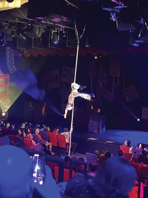 An acrobat performs between segments of Virgin's "Miss Behave" game show.