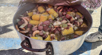 Lowcountry boil cooking over an outdoor fire in traditional Gullah Geechee style during a Black Cultural Heritage Tours trip.