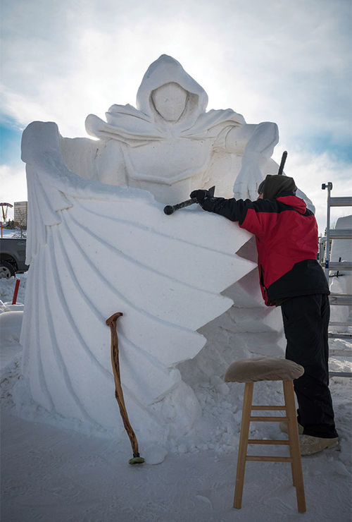 An artist works on an intricate snow sculpture at the start of Anchorage's Fur Rendezvous, a festival taking place over two weekends in February and March.