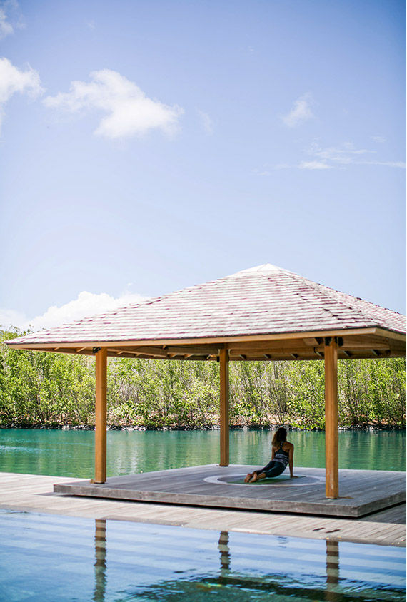 A guest does yoga at Amanyara in Turks and Caicos.