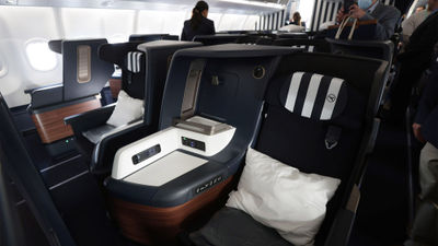 In business class, flyers have a lie-flat seat that extends 76 inches.