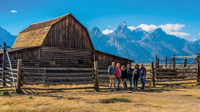 Guests on a Tauck small-group tour at the John Moulton Barn in Grand Teton National Park.
