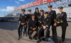 Delta pilots pose in front of the Fly Delta Jets sign at Hartsfield-Jackson International Airport in Atlanta.
