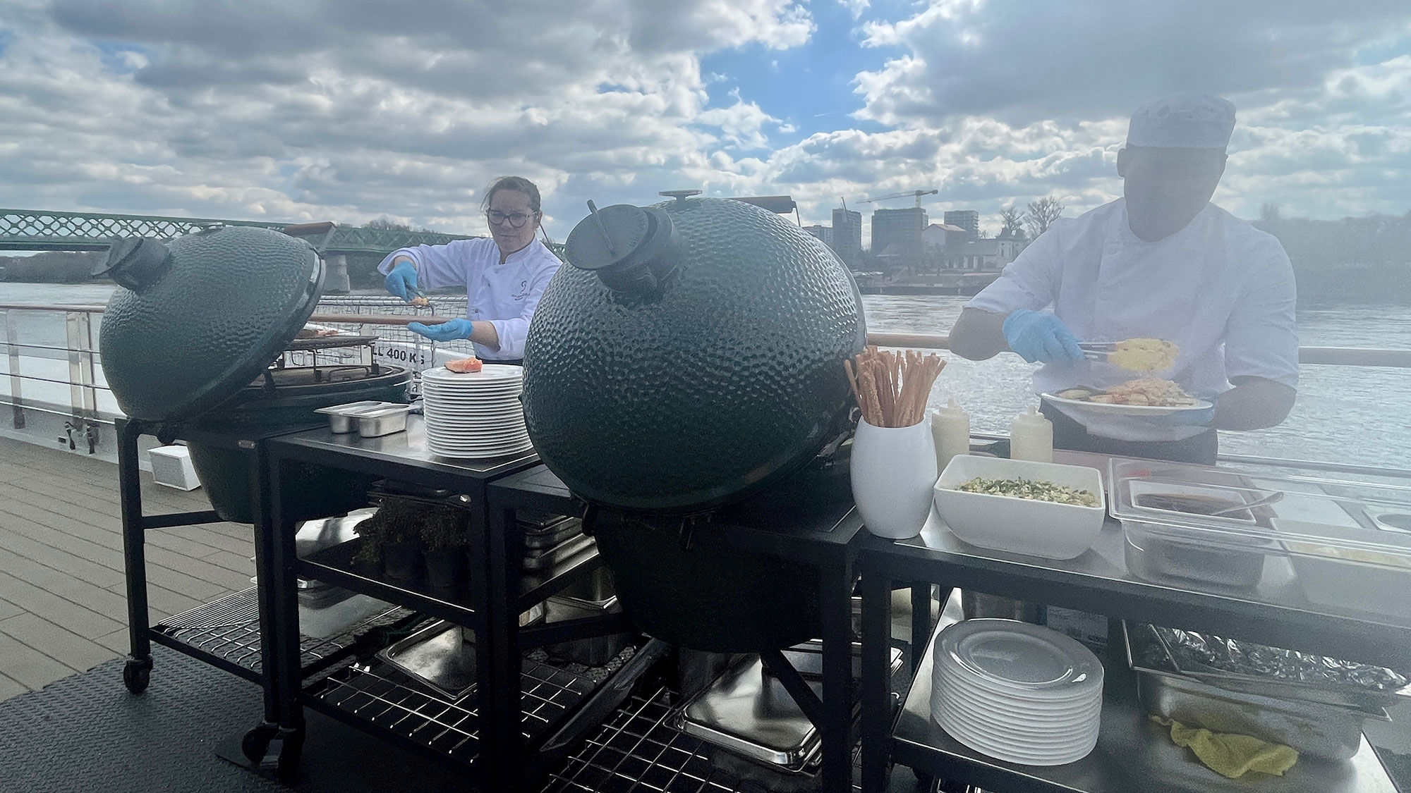 Riverside Mozart staff grill lunch for guests on the sun deck.