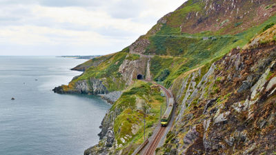 A train chugs along the coast of Ireland. Railbookers has expanded its offerings in Ireland with the addition of five itineraries for guests to explore several corners of the Emerald Isle.