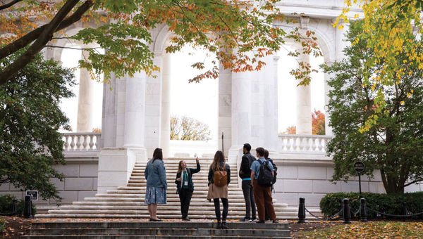 A guide leads a group on a City Experiences tour of Arlington National Cemetery. A guide leads a group on a City Experiences tour of Arlington National Cemetery.