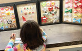 Choosing colorful charms for a Mickey ears craft at the resort's Pau Hana Room.