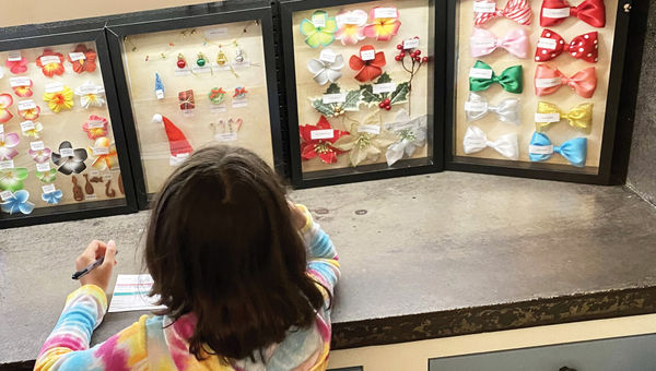 Choosing colorful charms for a Mickey ears craft at the resort's Pau Hana Room.