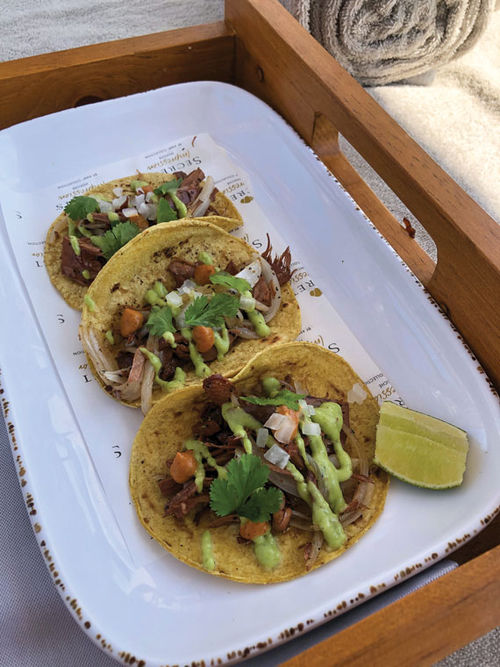 Vegan tacos made with shredded jackfruit is on the poolside rooftop menu.