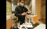 A server mixes a cocktail table side at Cocina de Autor.