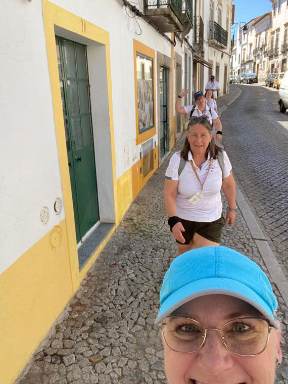 Rushing single-file along the narrow cobblestone sidewalks of Evora.