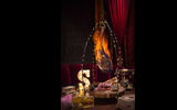 The Super Tomahawk is a bone-in ribeye hung from a trellis with lights.