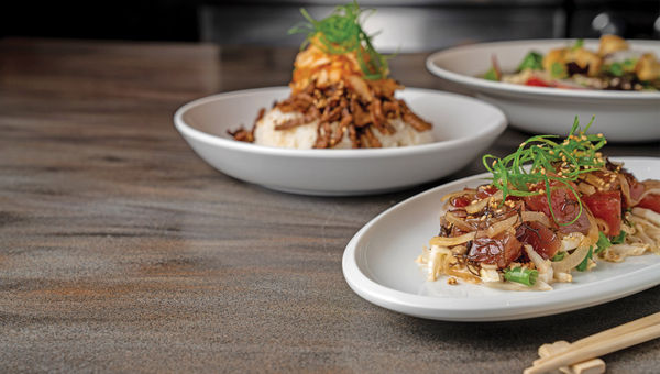 Ahi poke and other dishes served at Wai Kai's Lookout restaurant, which offers views of the wave pool and the watersports lagoon. Ahi poke and other dishes served at Wai Kai's Lookout restaurant, which offers views of the wave pool and the watersports lagoon.