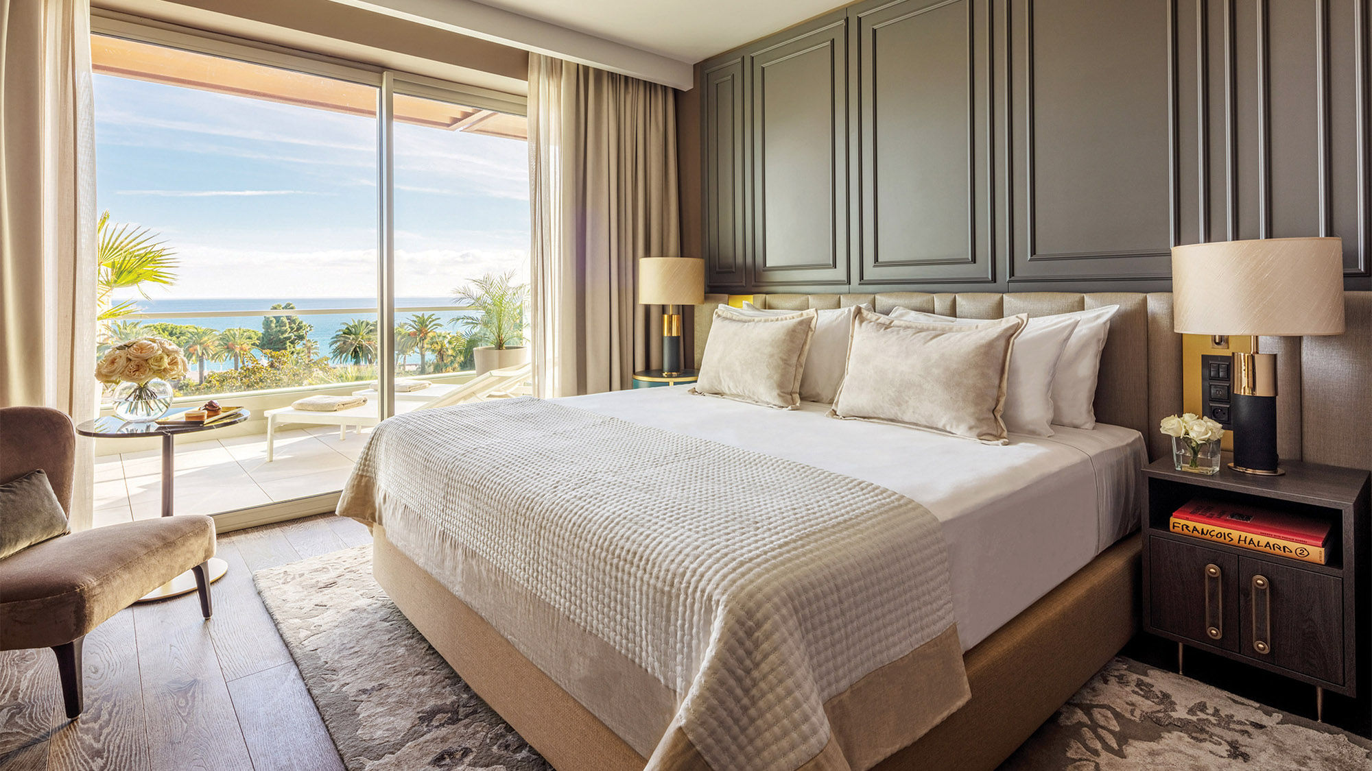 The bedroom and terrace of a guestroom at the Anantara Plaza Nice Hotel.