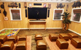 The movie room at Aunty's Beach House at Aulani, a Disney Resort & Spa. Aunty's is split into spaces for different activities, including crafting, video games and a shaded backyard