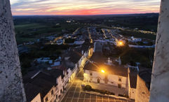 The white marble buildings of Estremoz from the Estremoz Castle as the sun sets.