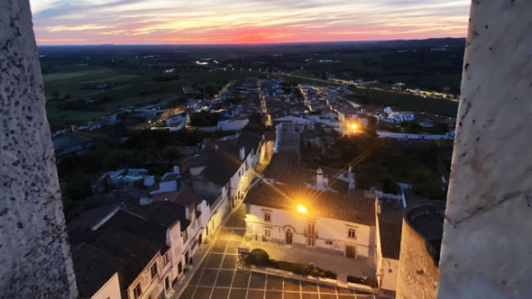 The white marble buildings of Estremoz from the Estremoz Castle as the sun sets.