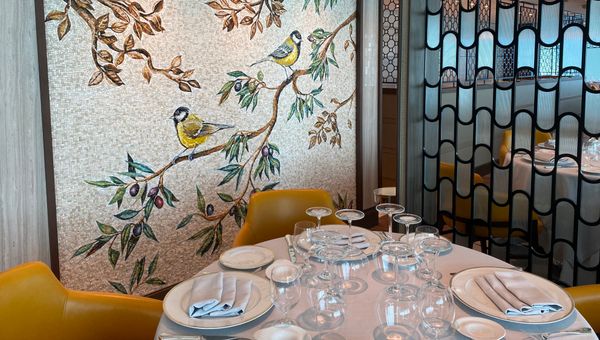 The Toscana restaurant features a contemporary design, like curved shapes in space dividers and art made of small rectangular tiles.