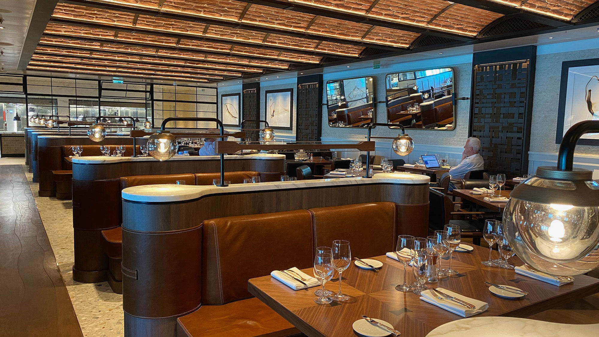 The design of the new Ember restaurant on the Oceania Vista features curved brick-like ceilings and an open kitchen serving up American-style cuisine.