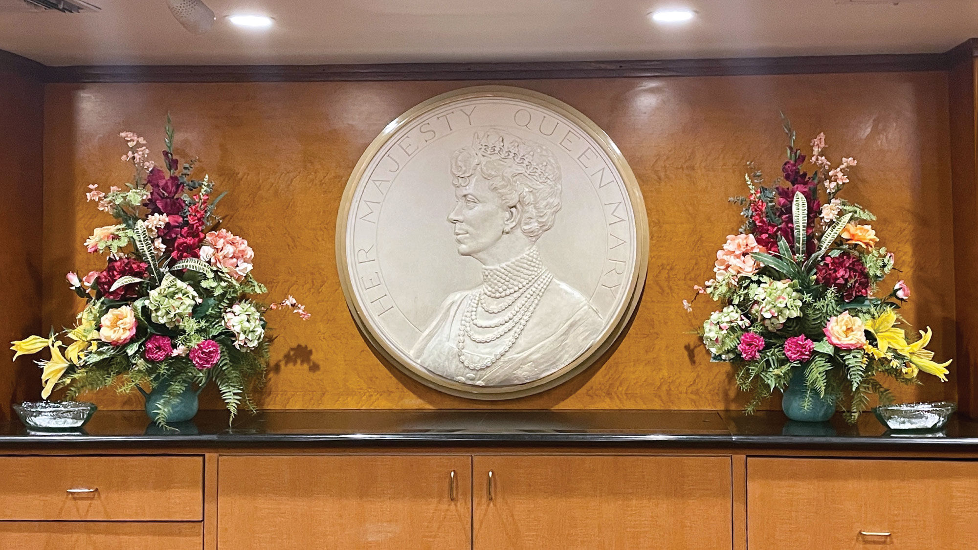 The front desk of the Queen Mary features a portrait of the queen herself.