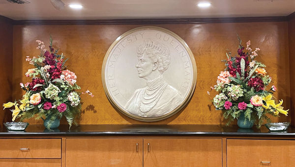 The front desk of the Queen Mary features a portrait of the queen herself. The front desk of the Queen Mary features a portrait of the queen herself.